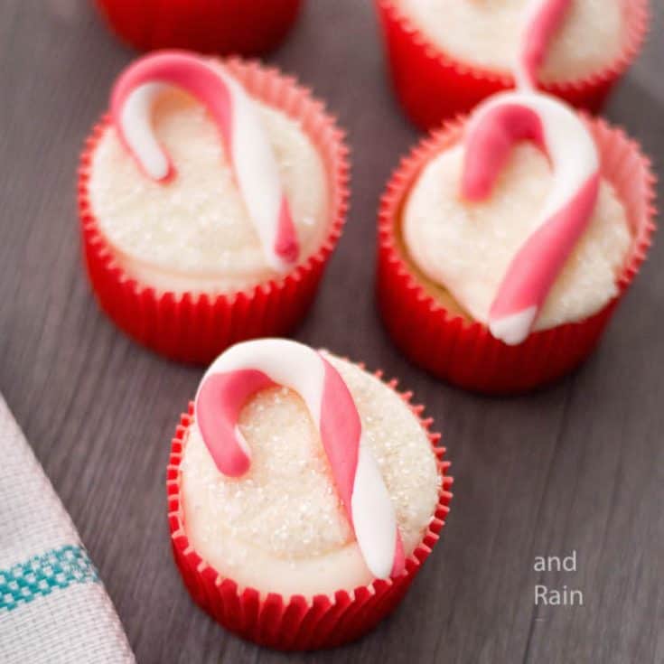 easy candy cane cupcakes for christmas on a dark wood table