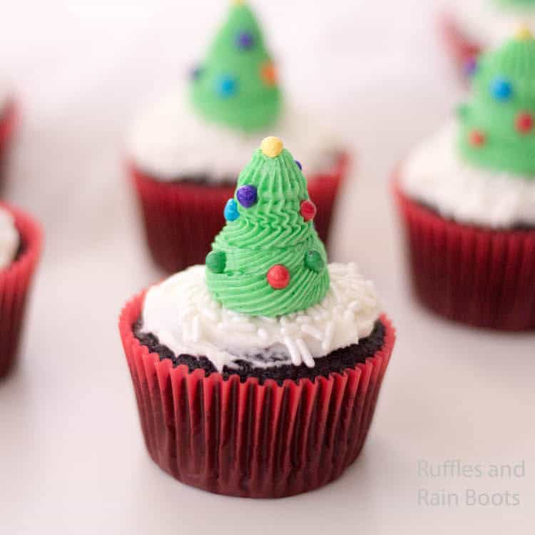 side view of easy christmas tree cupcakes made with icing on a white table