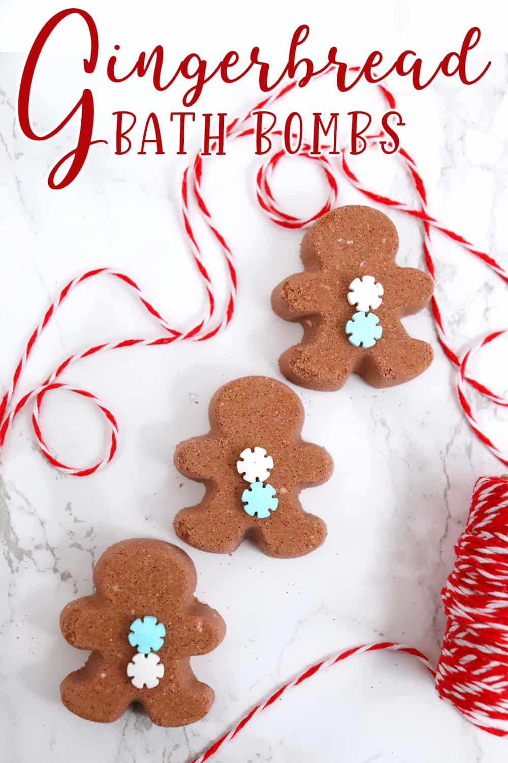 three gingerbready man bath bombs on a white background with red and white string with text which reads gingerbread bath bombs