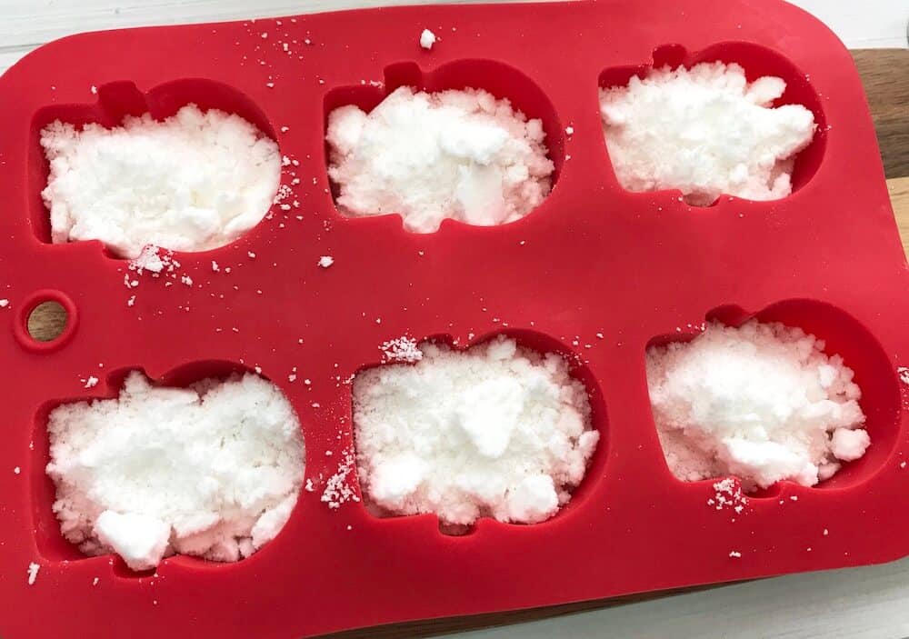 how to make snowman shower bombs step 4 add mix to molds