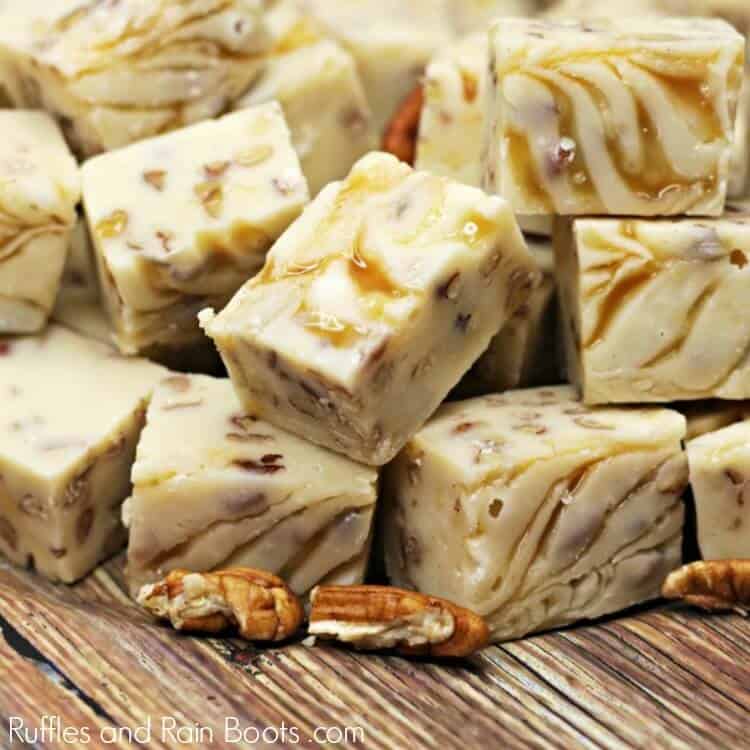Caramel Pecan Fudge Recipe in a pile on a wood table