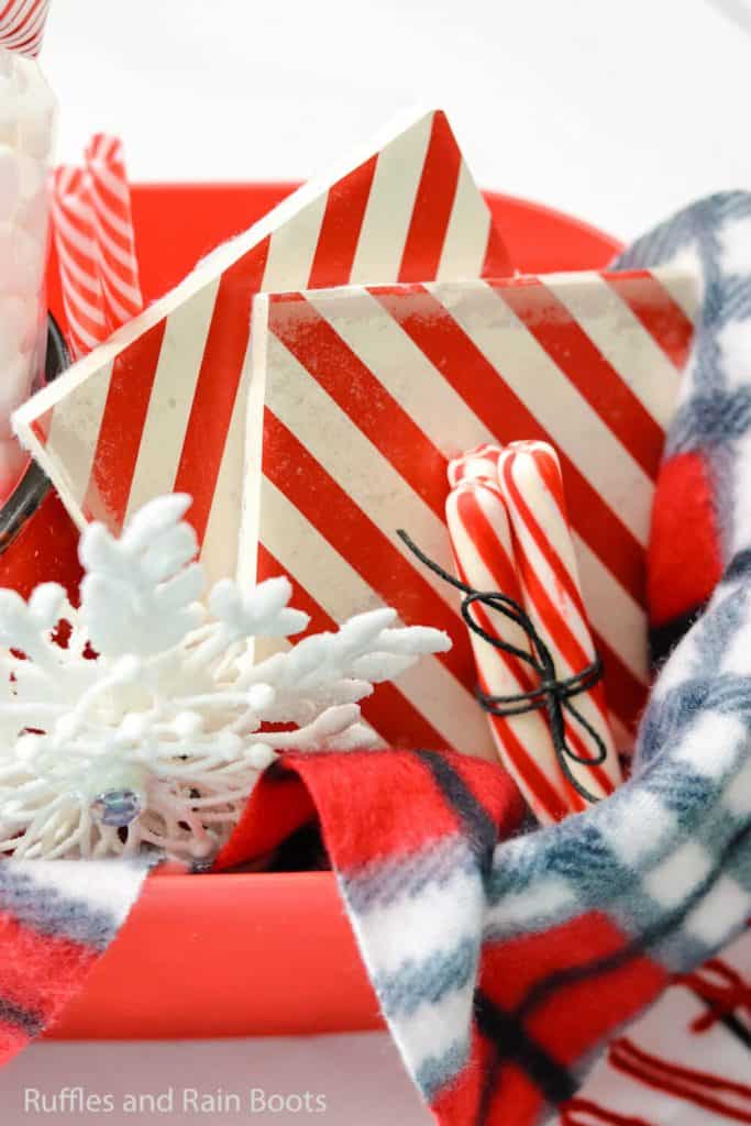 Vertical image of decoupage tiles made into Christmas coasters as part of a gift basket or hostess gift idea.