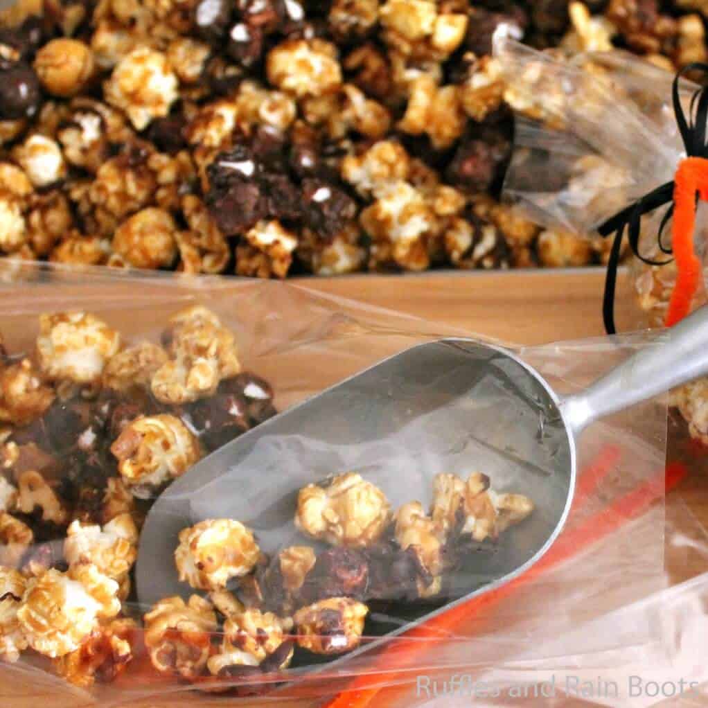 Close up of caramel and chocolate popcorn with metal scoop.