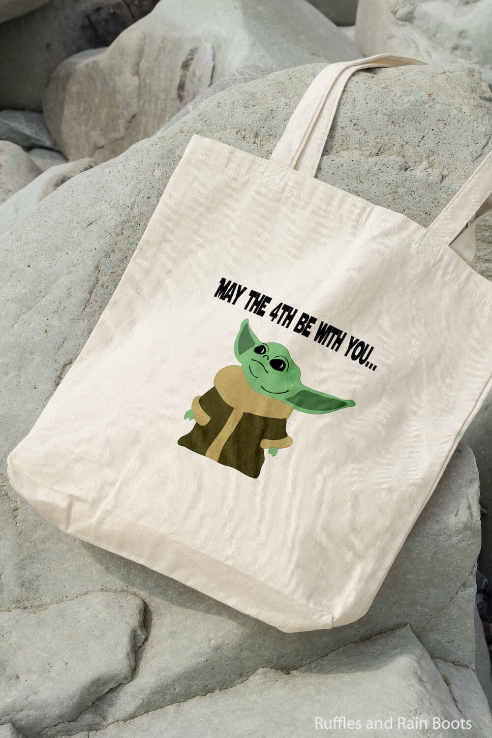 baby yoda svg file for cricut or silhouette on a canvas bag on rocks