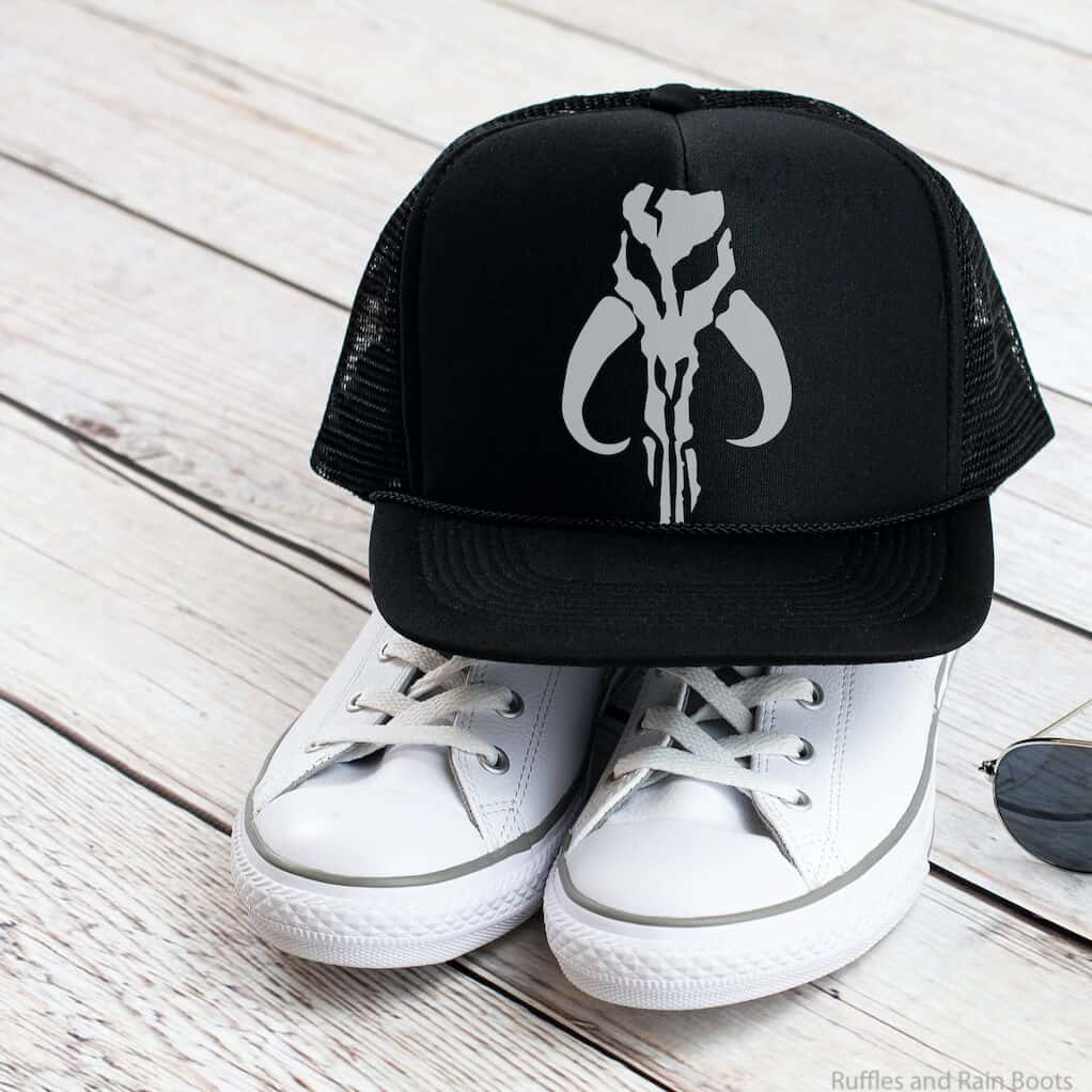 mandalorian skull cut file for cricut or silhouette on a ball cap sitting on shoes