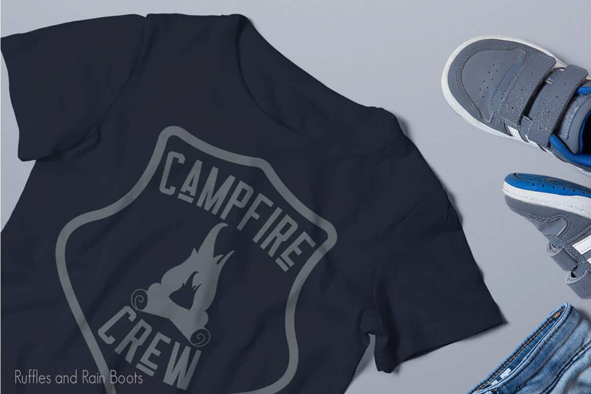 Campfire Crew SVG on a black tshirt on a white table