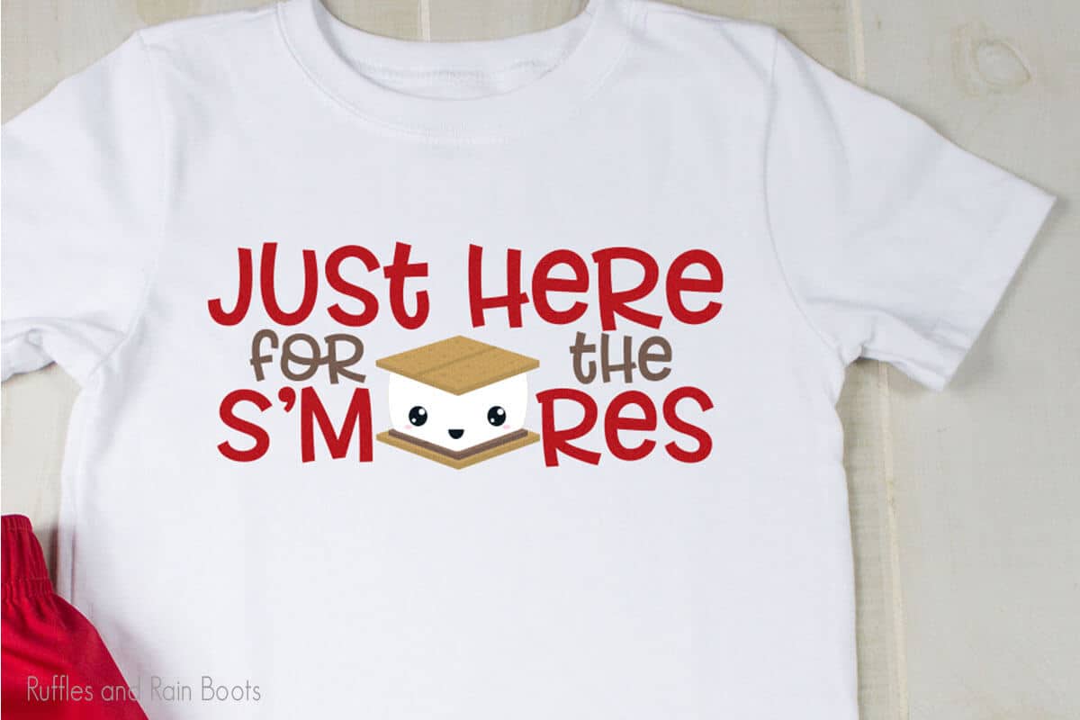 Just Here for the Smores SVG on a tshirt laying on a table