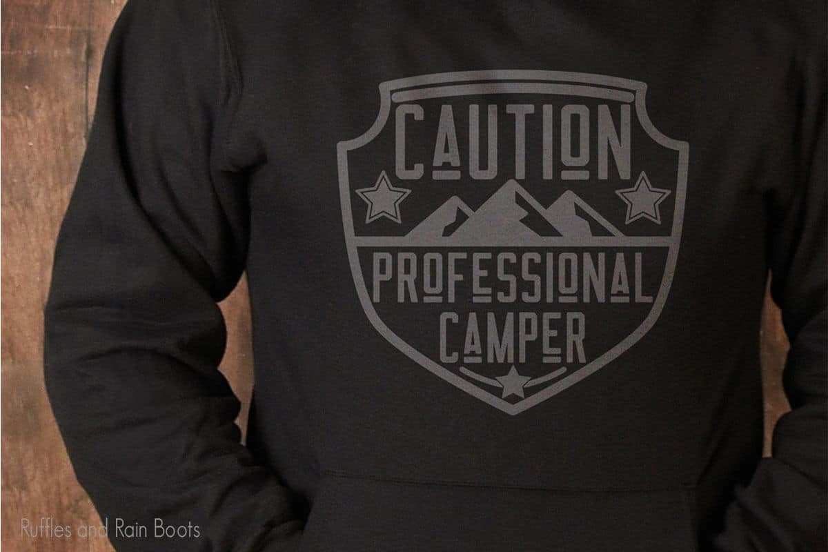 Professional Camper SVG on a black sweatshirt worn by a man