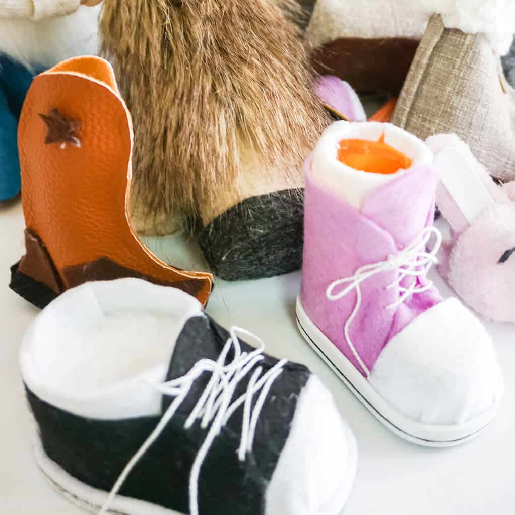 several gnome boots and gnome shoes on a white table