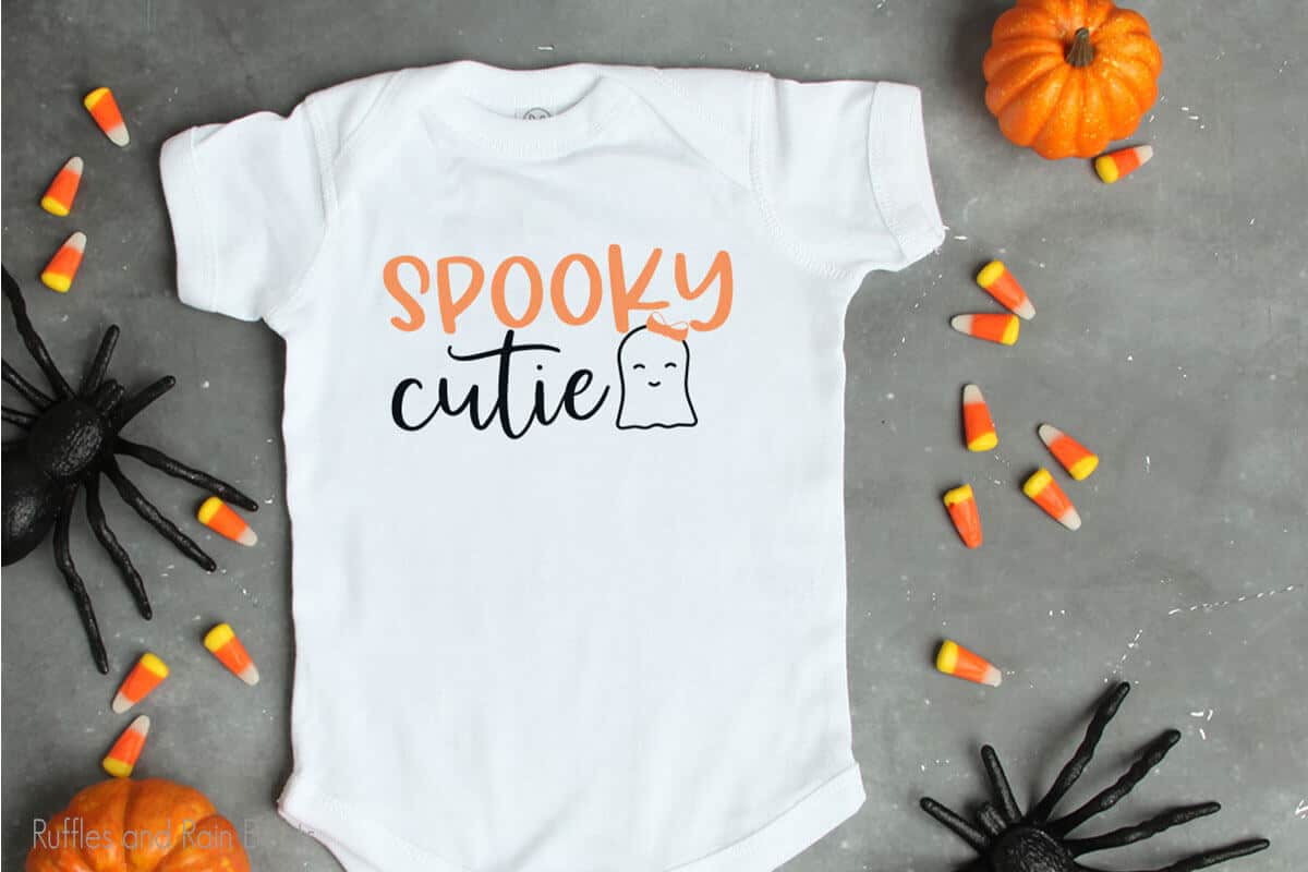 Spooky Cutie halloween svg file set for cricut or silhouette on a onesie laying on a table