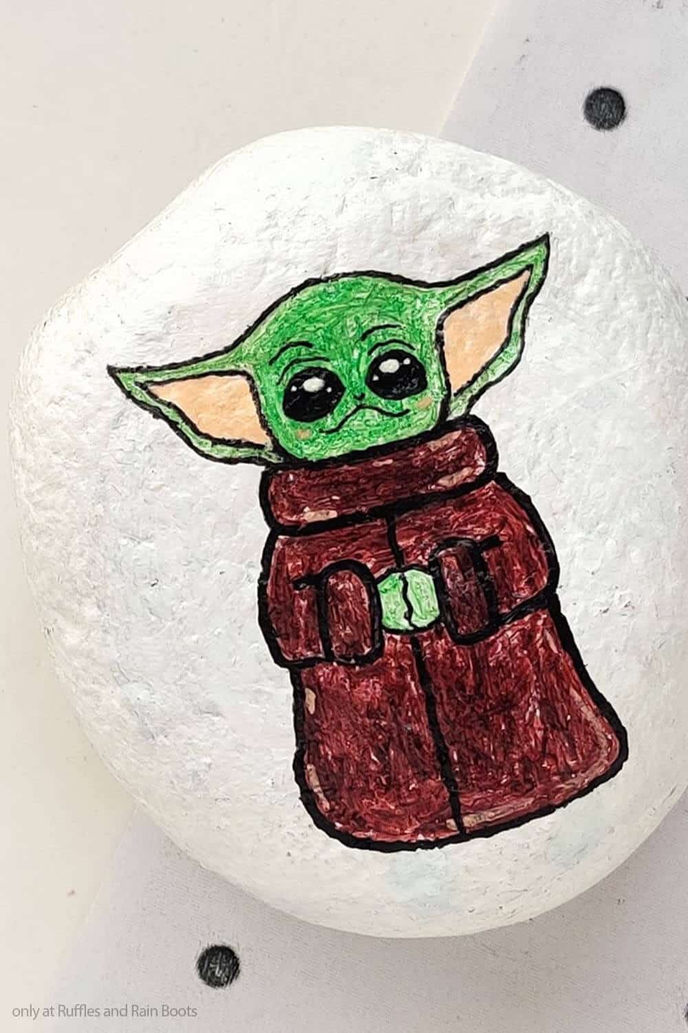 closeup of easy diy star wars painted rock craft with baby yoda