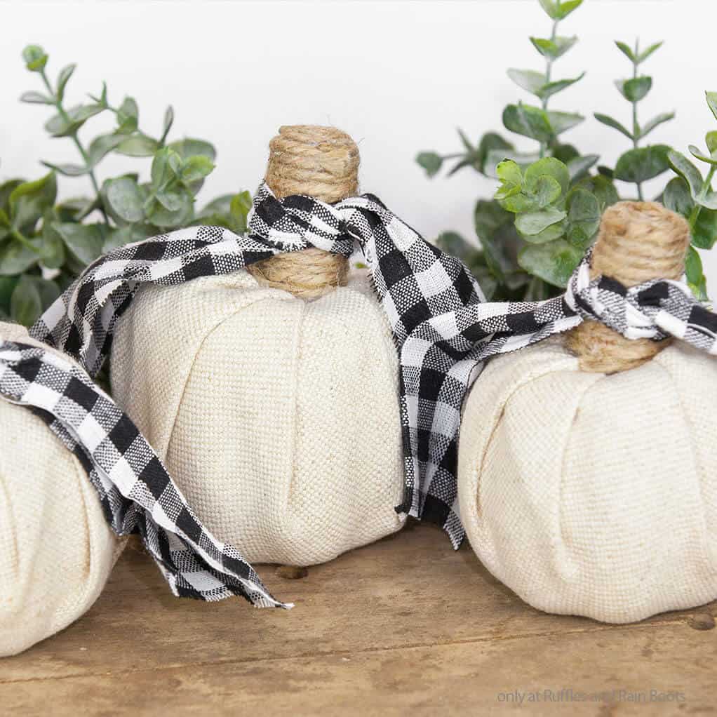 three fabric covered pumpkins made with supplies from the dollar tree