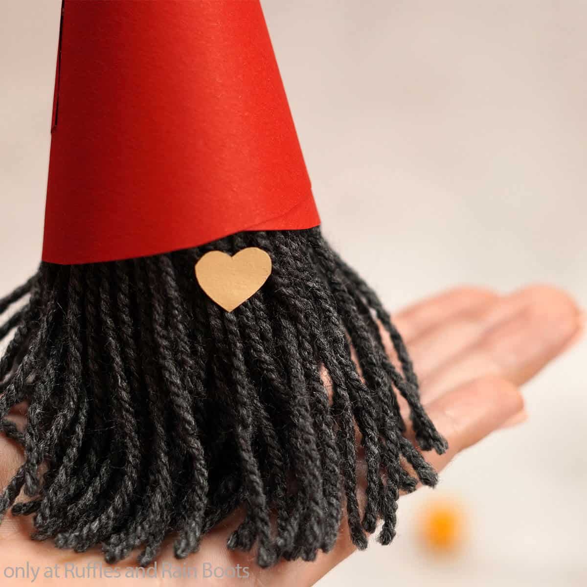 hand holding a paper tube gnome kids craft