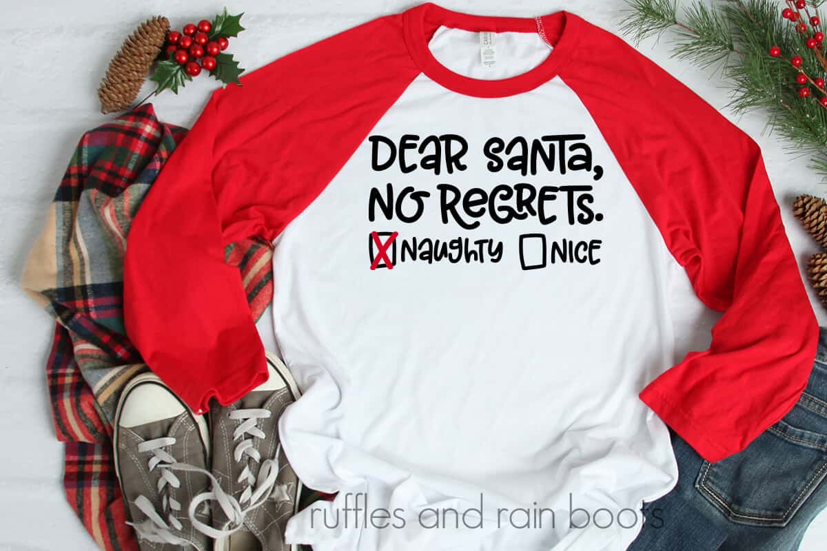 Dear Santa SVG No Regrets Naughty List on a tshirt laying on a table