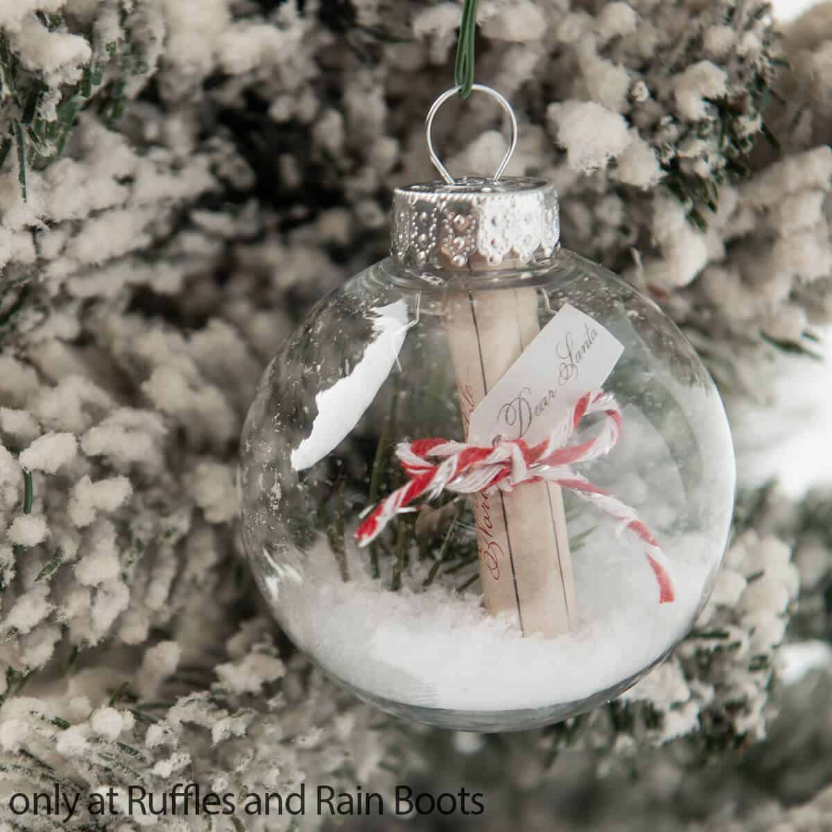 Very close up image of a clear Christmas ornament DIY with a letter to Santa Claus captured inside.