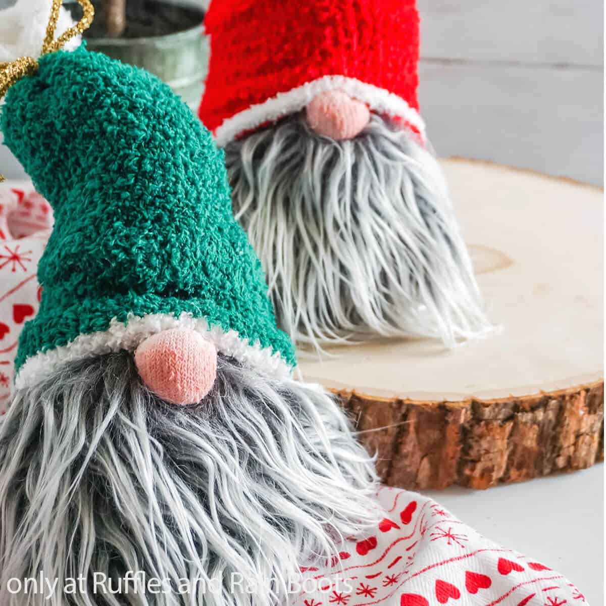 Close up of a sock gnome with green hat pattern and gray beard on holiday background with no text.