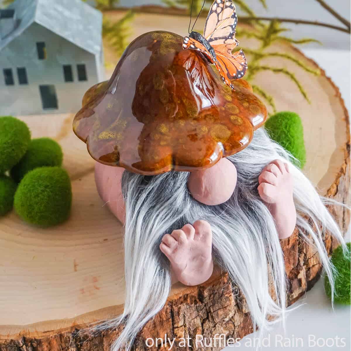 Close up image of a handmade mushroom gnome make with a dollar tree ceramic mushroom.