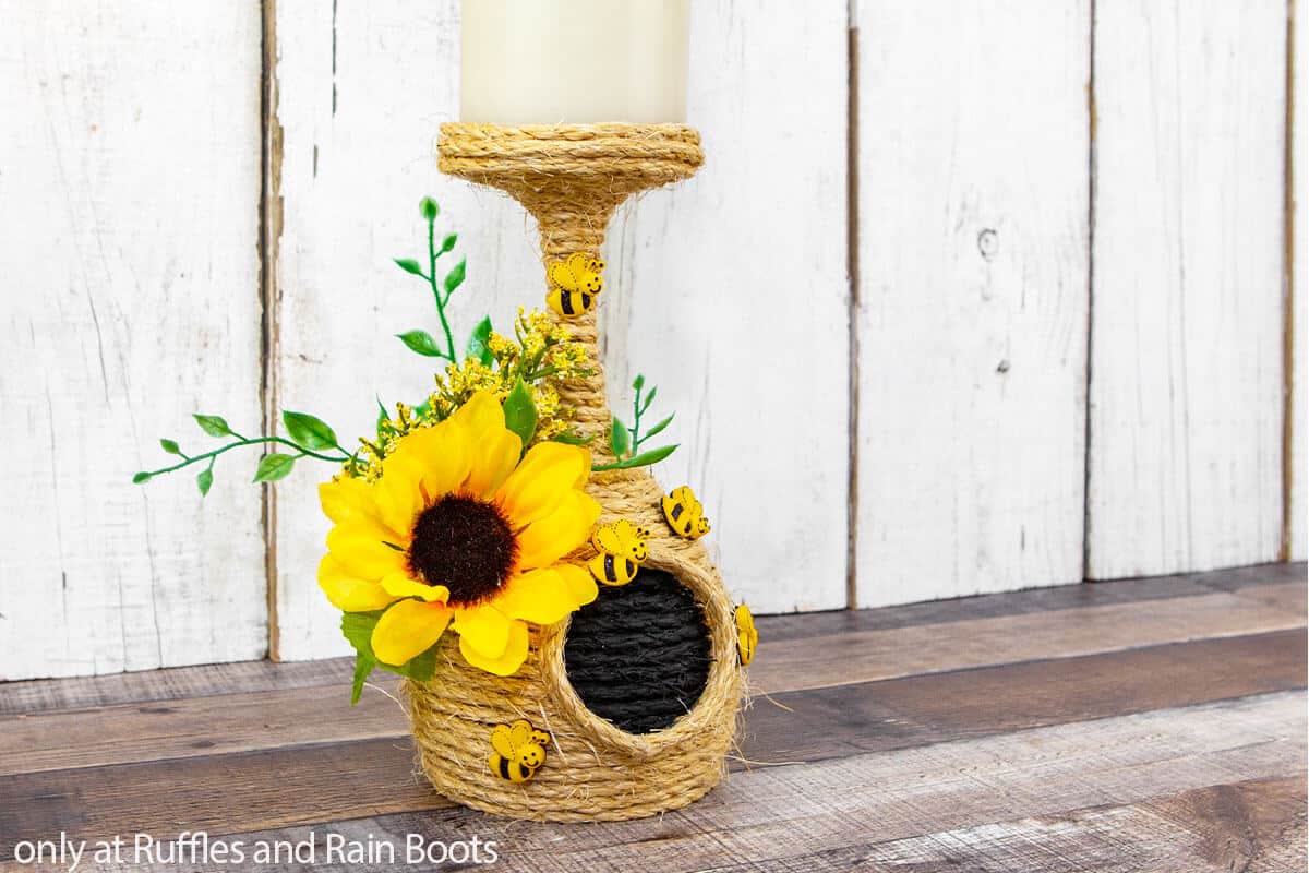 Horizontal image of a candle holder beehive craft from dollar tree supplies. 