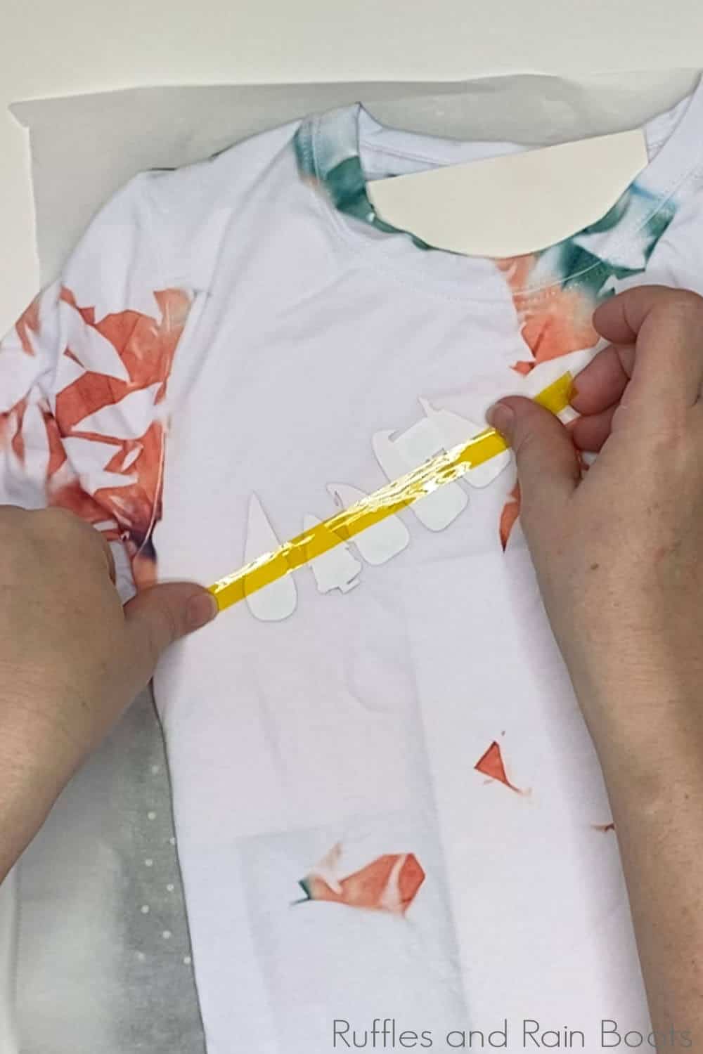 in-process step of taping gnome design on a shirt to make a tik tok sublimation glass shard shirt with gnomes