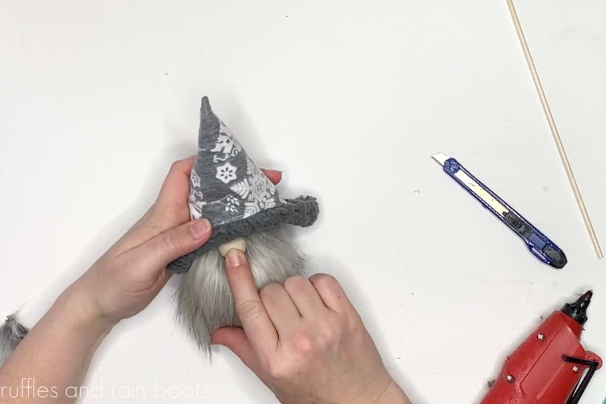 step 6 of reversible gnome hat pattern add gnome nose by splitting fur to the fabric backing and adding hot glue