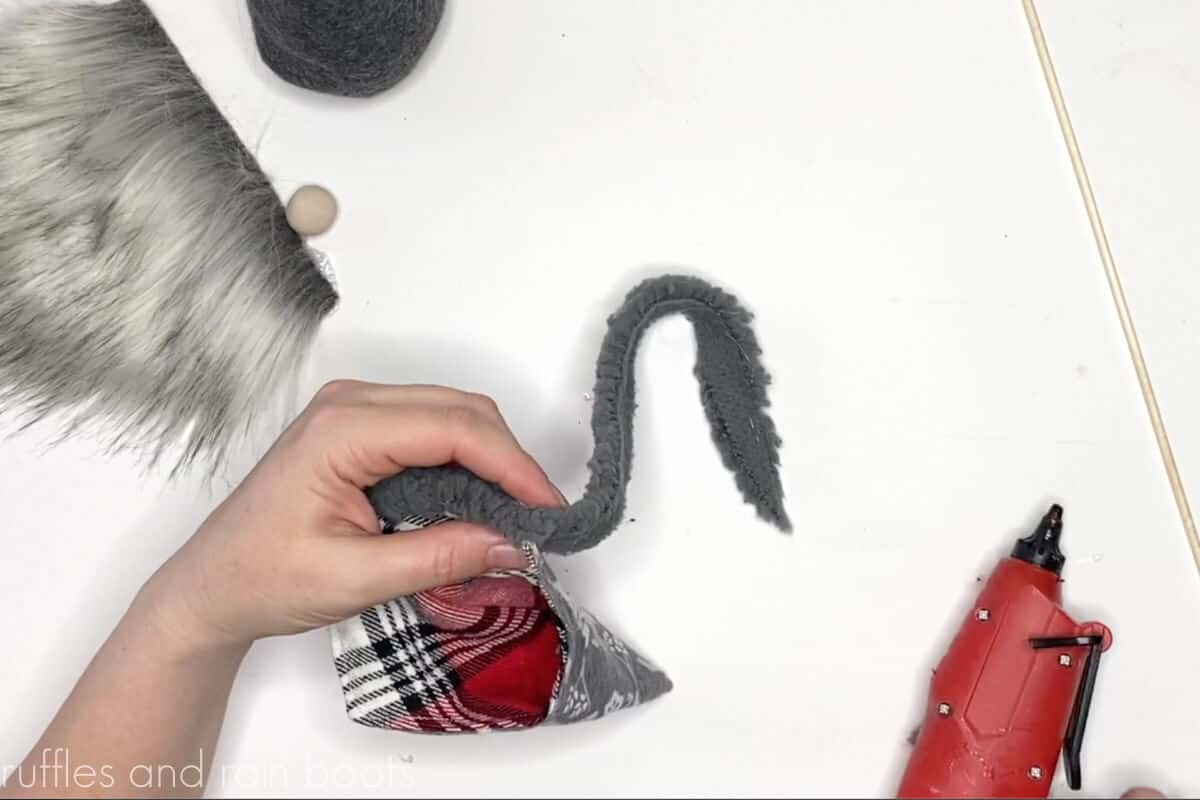 step 8 of making a reversible hat gnome add fluffy trim to brim of gnome hat
