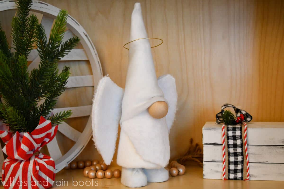 DIY dollar tree angel gnome free pattern shown made in white angel with wings against a Christmas backdrop and no text