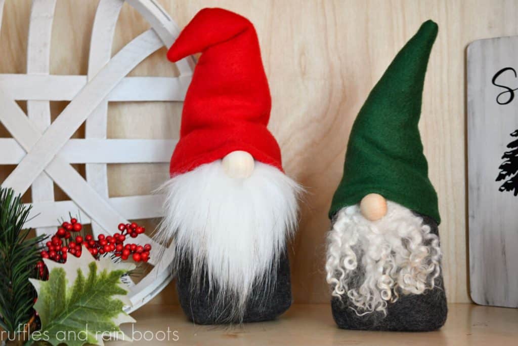horizontal image of two gnomes made with a free pattern one with red hat and white fur beard and other white green hat and wool locks beard