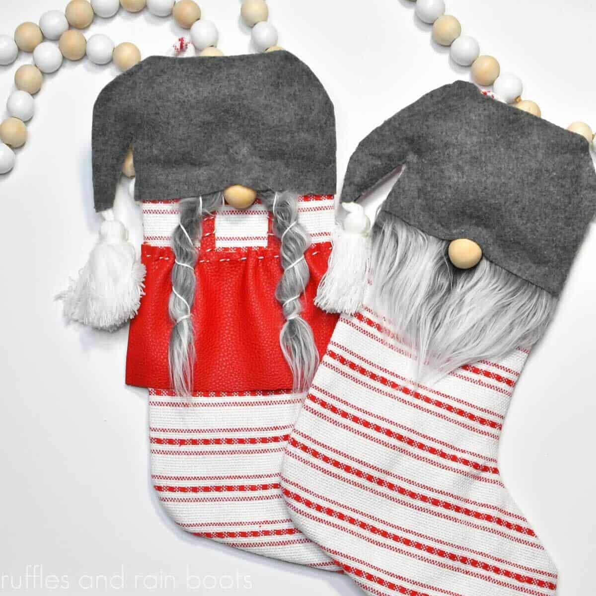 two gnome stockings on white table with white and natural wood bead garland in background S