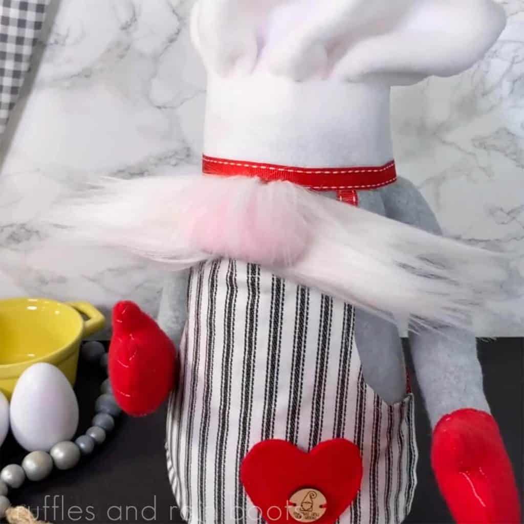 square image of a large chef gnome with a striped apron and heart pocket with chef hat and white mustache