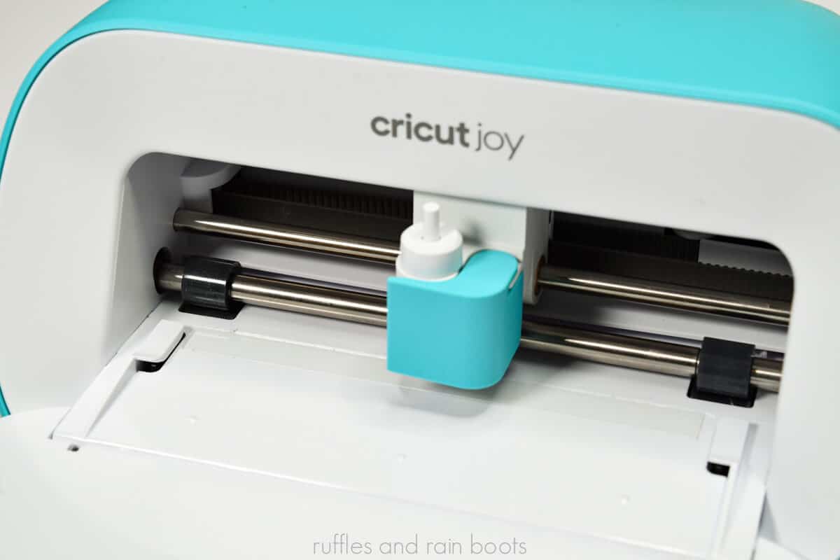 Close up view of an open Cricut Joy machine with blade and housing shown.