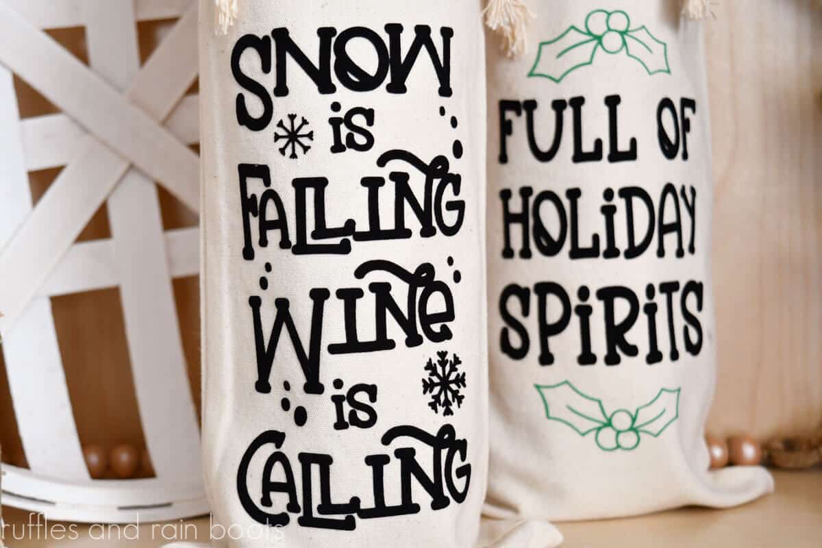 Horizontal image of a close up of snow is falling wine is calling Christmas wine bag made with Cricut Joy in front of another holiday wine bottle gift bag made with flock htv,
