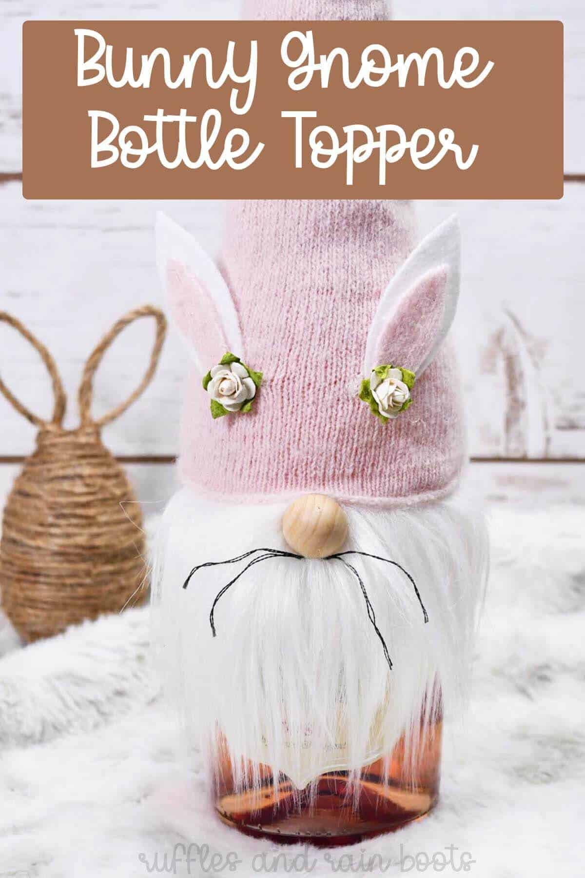 Vertical image of a bottle of rose wine on a fur backdrop and twine bunny egg covered with a bunny gnome bottle topper with a pink hat with text overly which reads bunny gnome bottle topper.