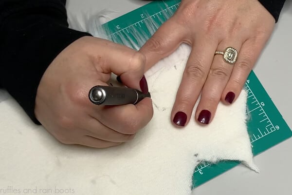 Learn how to cut faux fur by using a razor or Xacto knife on the fabric backing only.