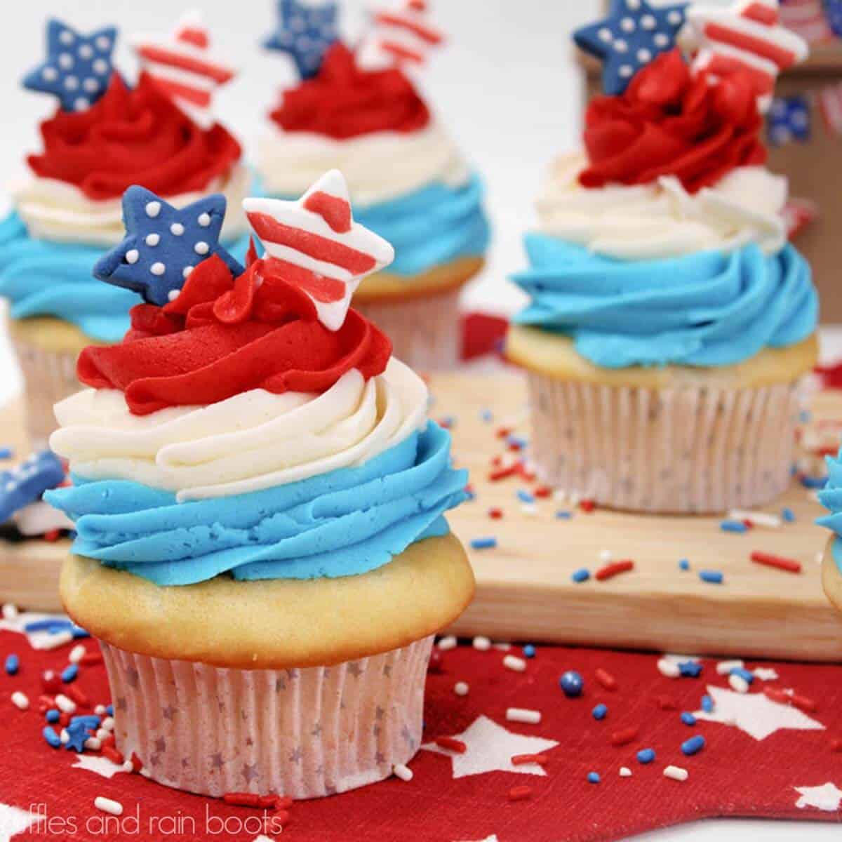 Square close up image of 4th of July cupcakes with red white and blue frosting and stars.