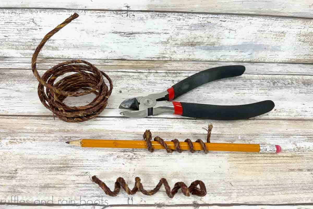Wired twine, wire cutters, and pencil showing how to create a pumpkin vine by wrapping the twine on a pencil.