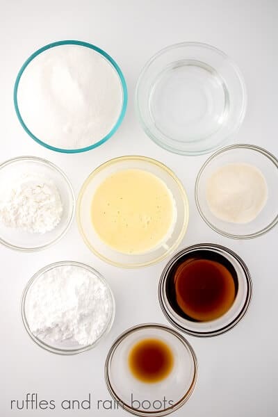 Overhead image of Homemade Eggnog Ingredients in small round glass bowls on a white surface
