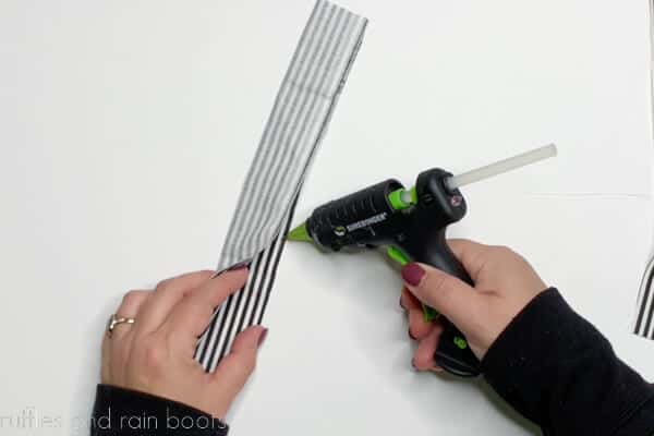 Crafter gluing gnome leg pattern pieces together.