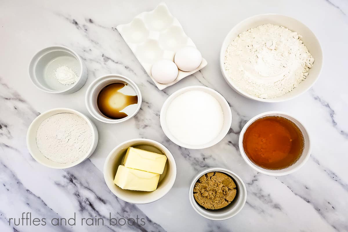 Horizontal overhead image of the ingredients for the Butterbeer Cupcakes Recipe on a white marble surface.