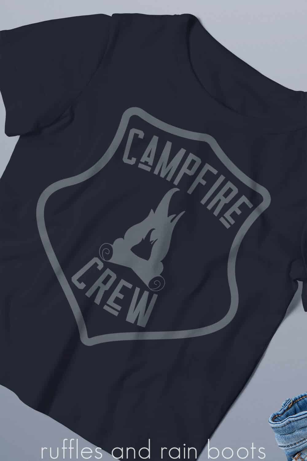 Vertical image of dark blue shirt with gray vinyl which reads campfire crew.
