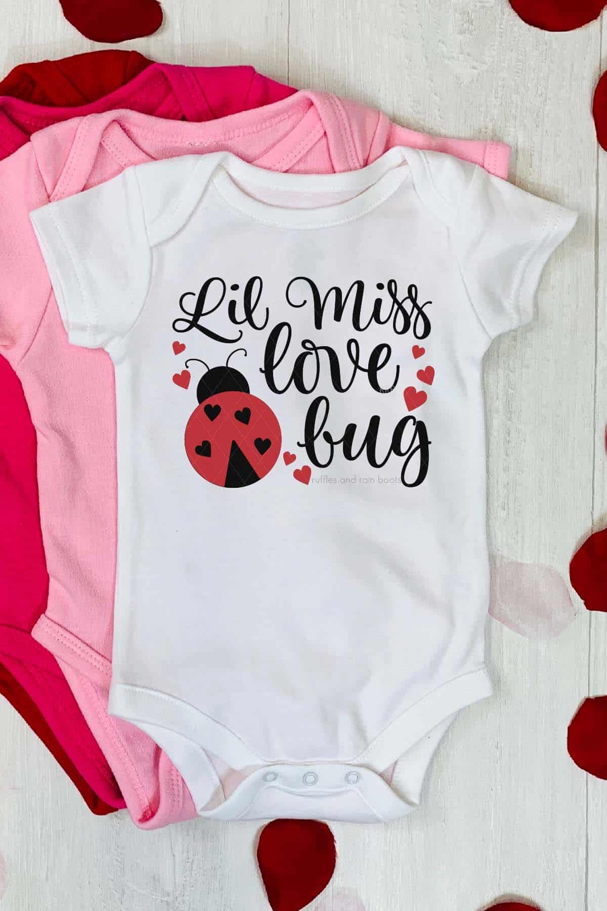 Vertical image of Lil Miss Love Bug with lady bug SVG on baby bodysuit in heat transfer vinyl from Cricut.