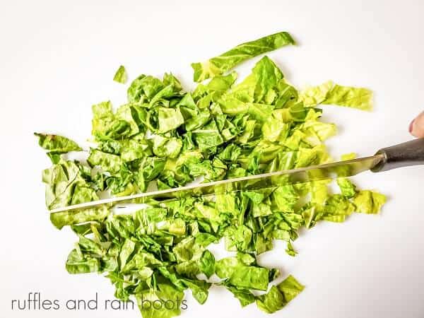 Lettuce for the Club Sandwich Pinwheels Recipe being chaooped with a large knife