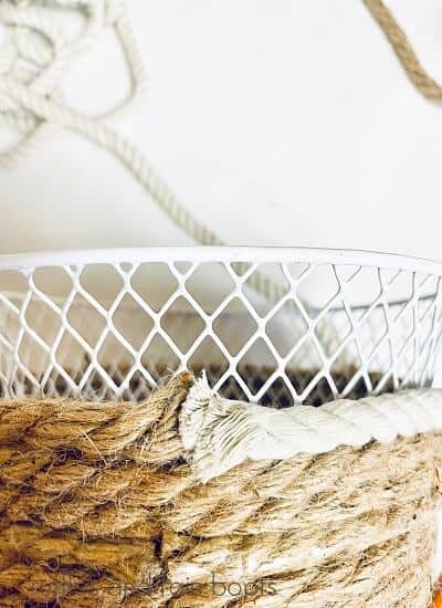 Close up of a Farmhouse Rope Bunny Basket with jute and white rope on a white surface and a white background.