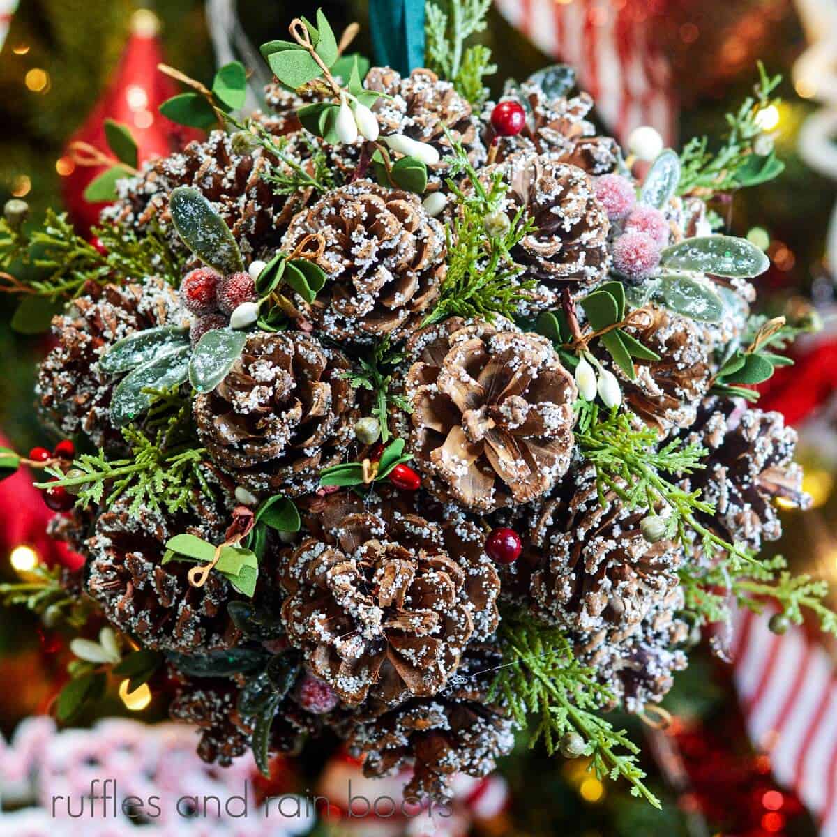 A close-up of the pinecone kissing ball for Christmas, hanging from a ribbon.