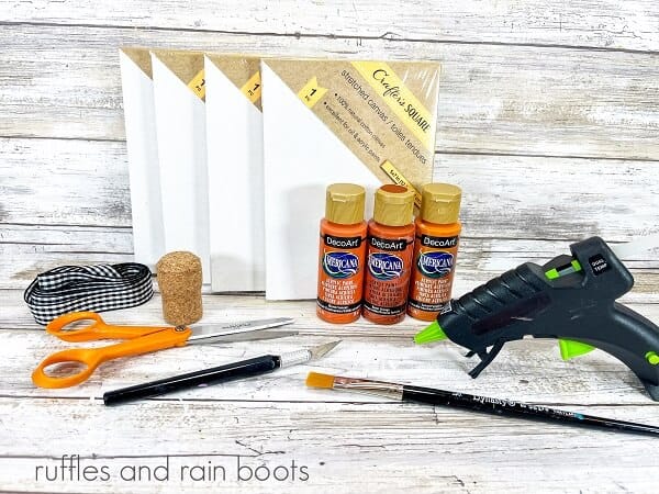 Supplies for the lighted canvas Jack-O-Lantern against a white weathered wood background.