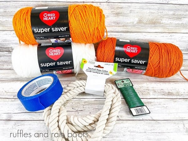 The supplies for DIY Rope jack-o-lanterns against a white weathered wood background.