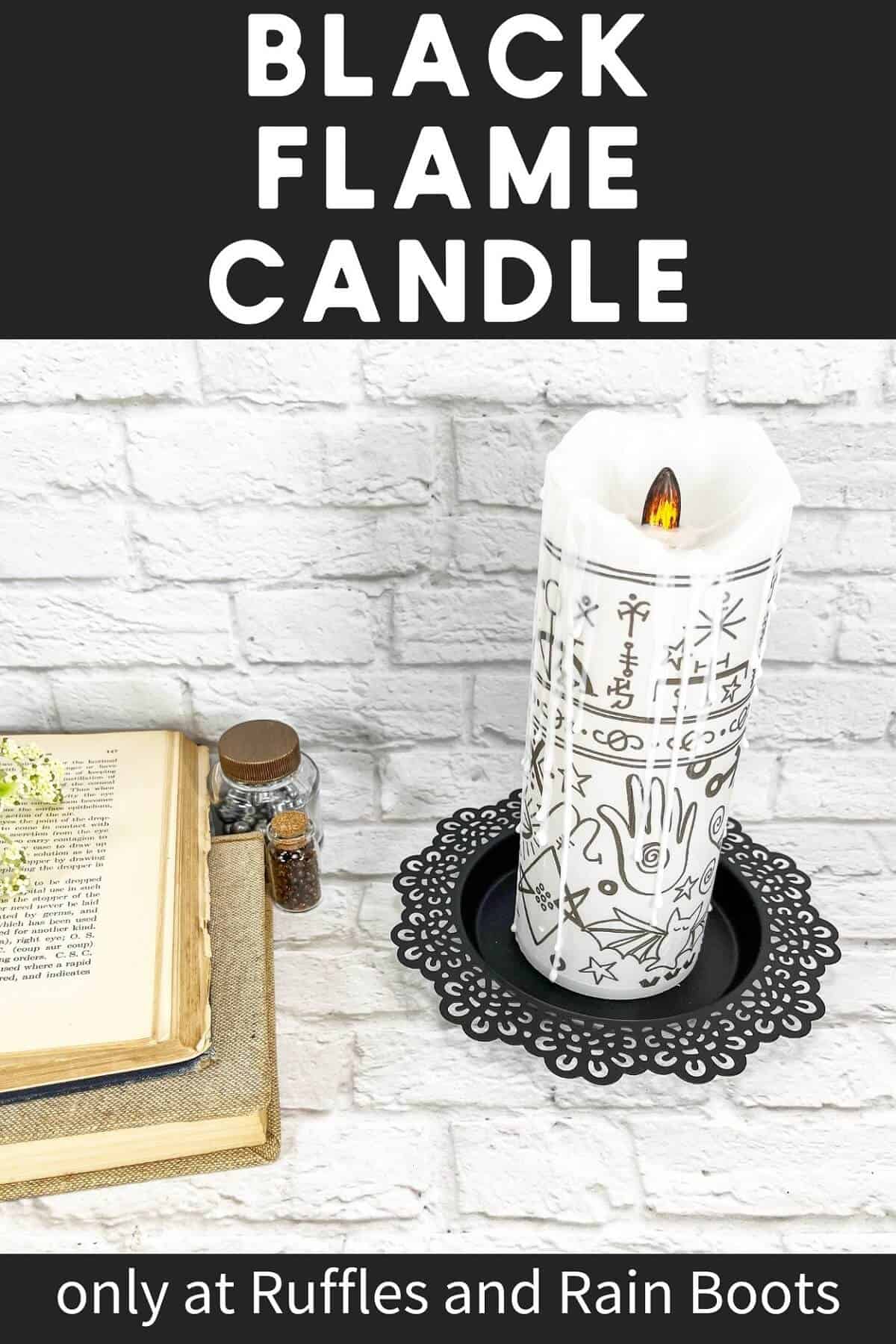 A vertical image of a Hocus Pocus Black Flame Candle, next to a few potion bottles and books against a white brick background.