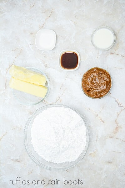 Ingredients for the frosting on top of a white marble surface.