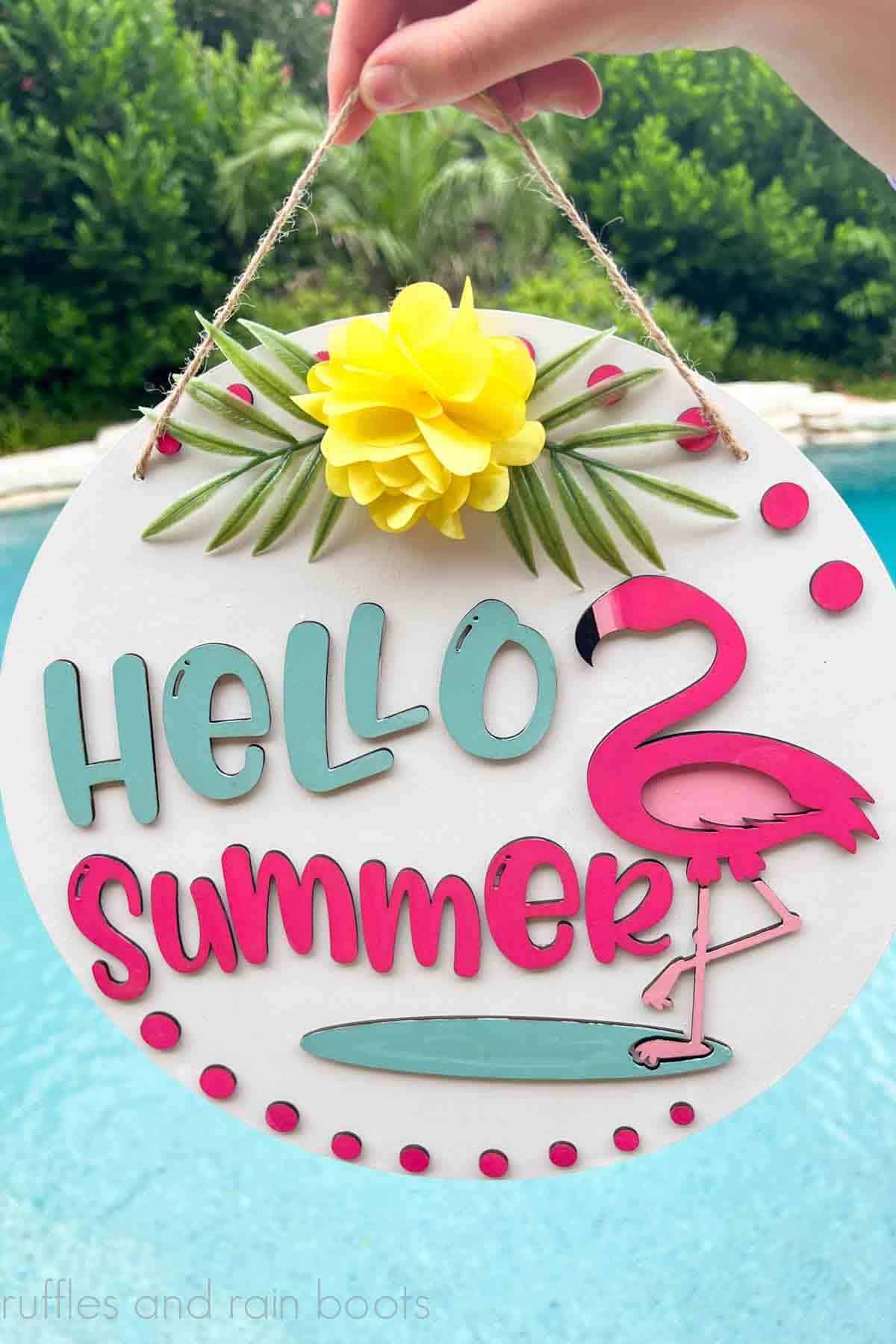 Vertical image of a summer door sign made with the xTool M1 shown in front of a pool.