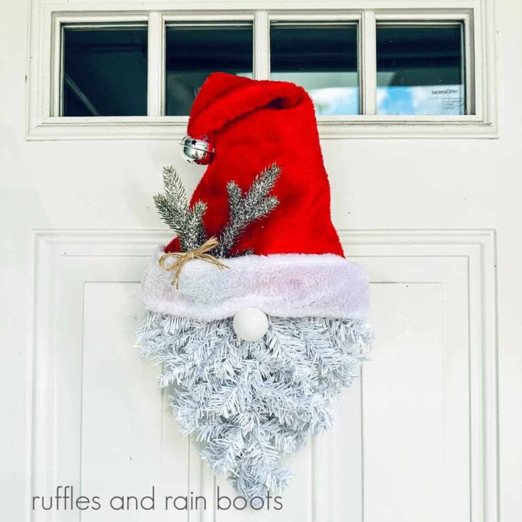 Dollar Tree Santa Gnome Wreath hanging on a white door with four windows