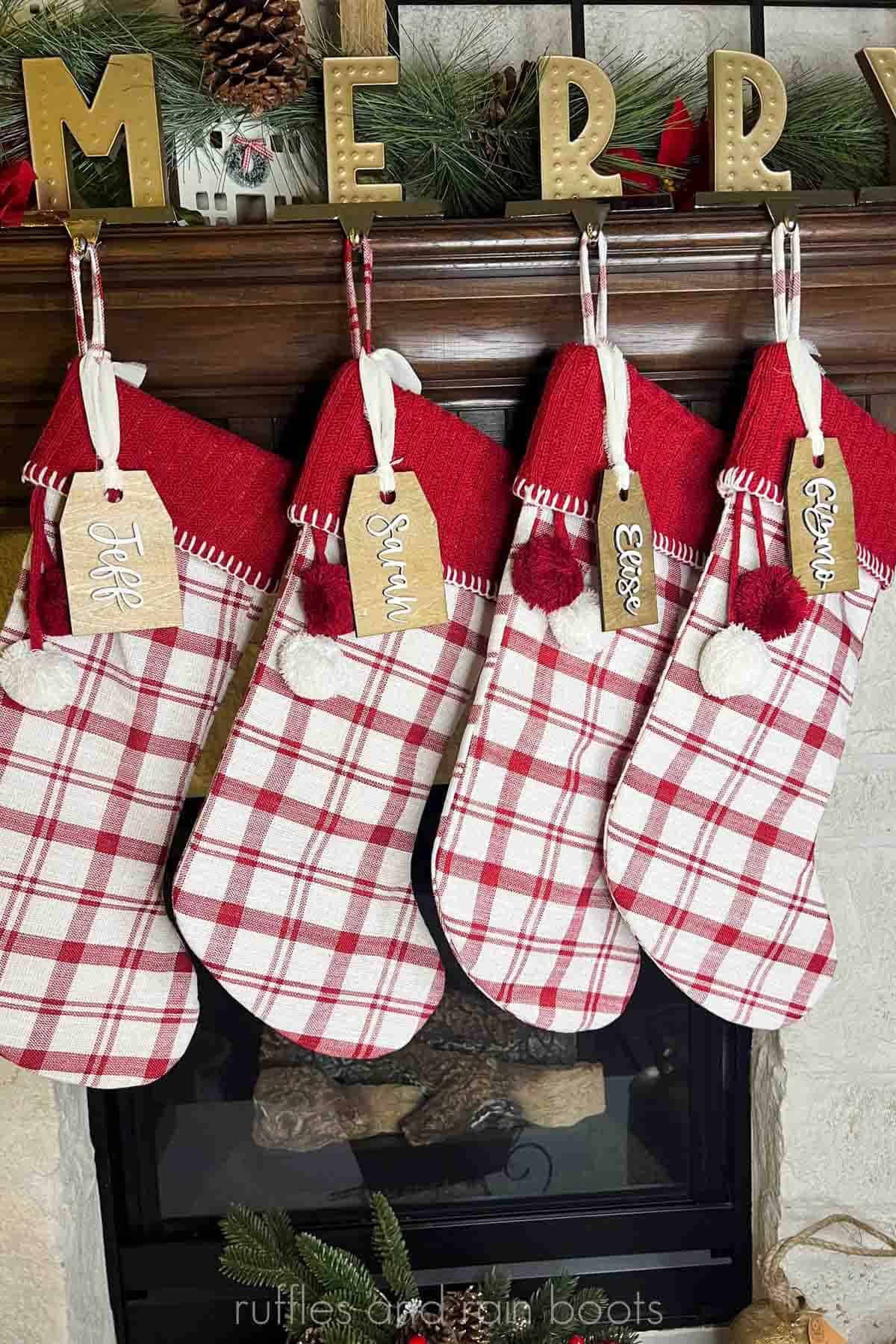 Vertical image of four stockings on a mantle with wood stocking tags made with an xTool S1 laser.